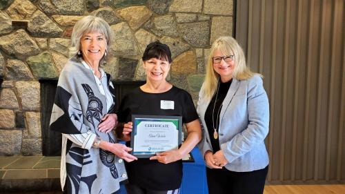 Anne Wiebe presented with the Service Award certificate for completion of 10 years of service at Fraserside