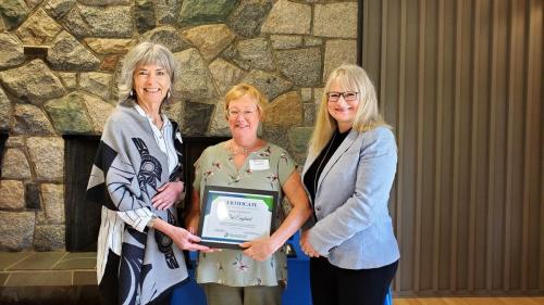 Pat England presented with the Service Award certificate for completion of 10 years of service at Fraserside